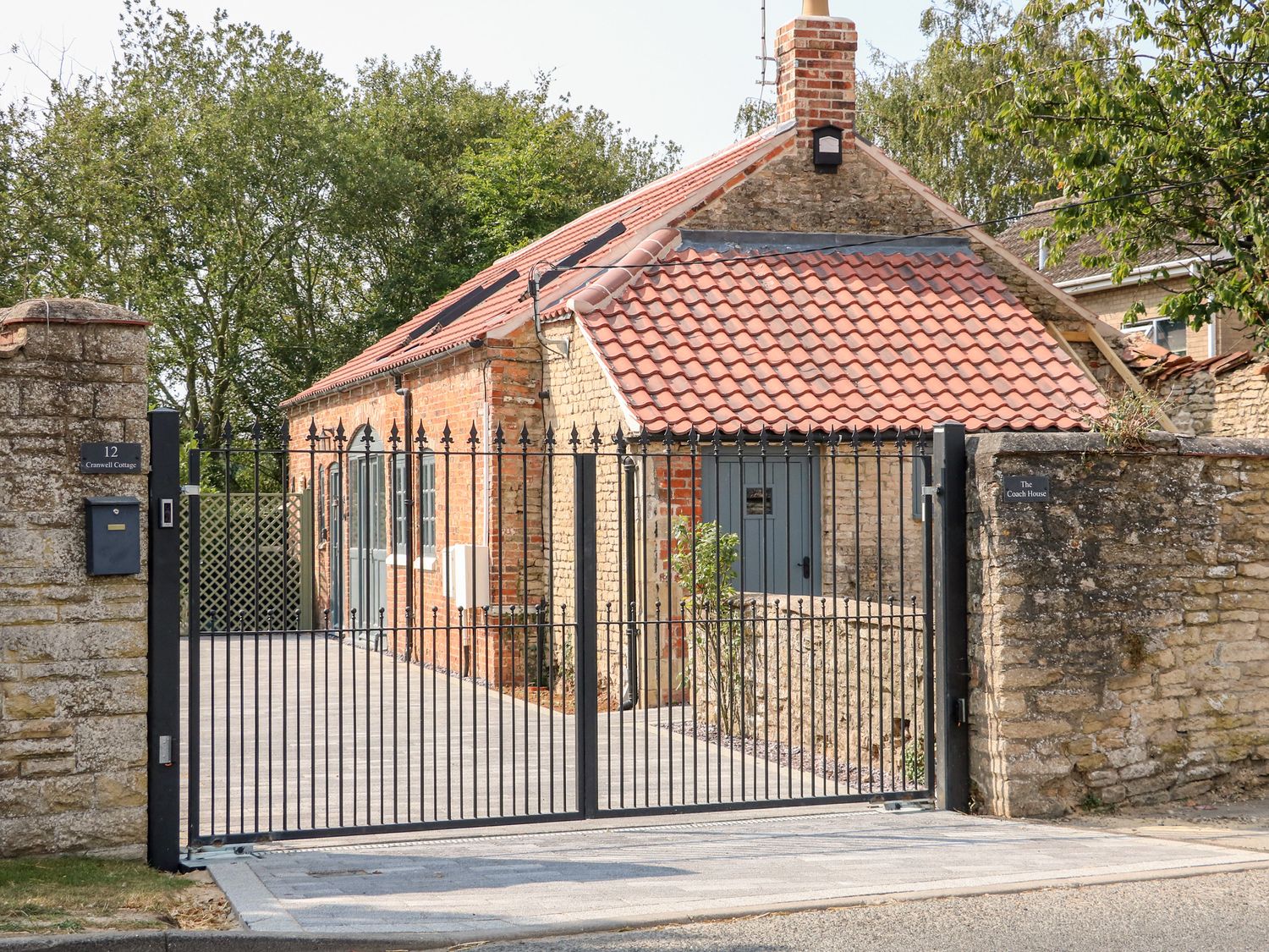 The Coach House behind electric gates in Cranwell Village