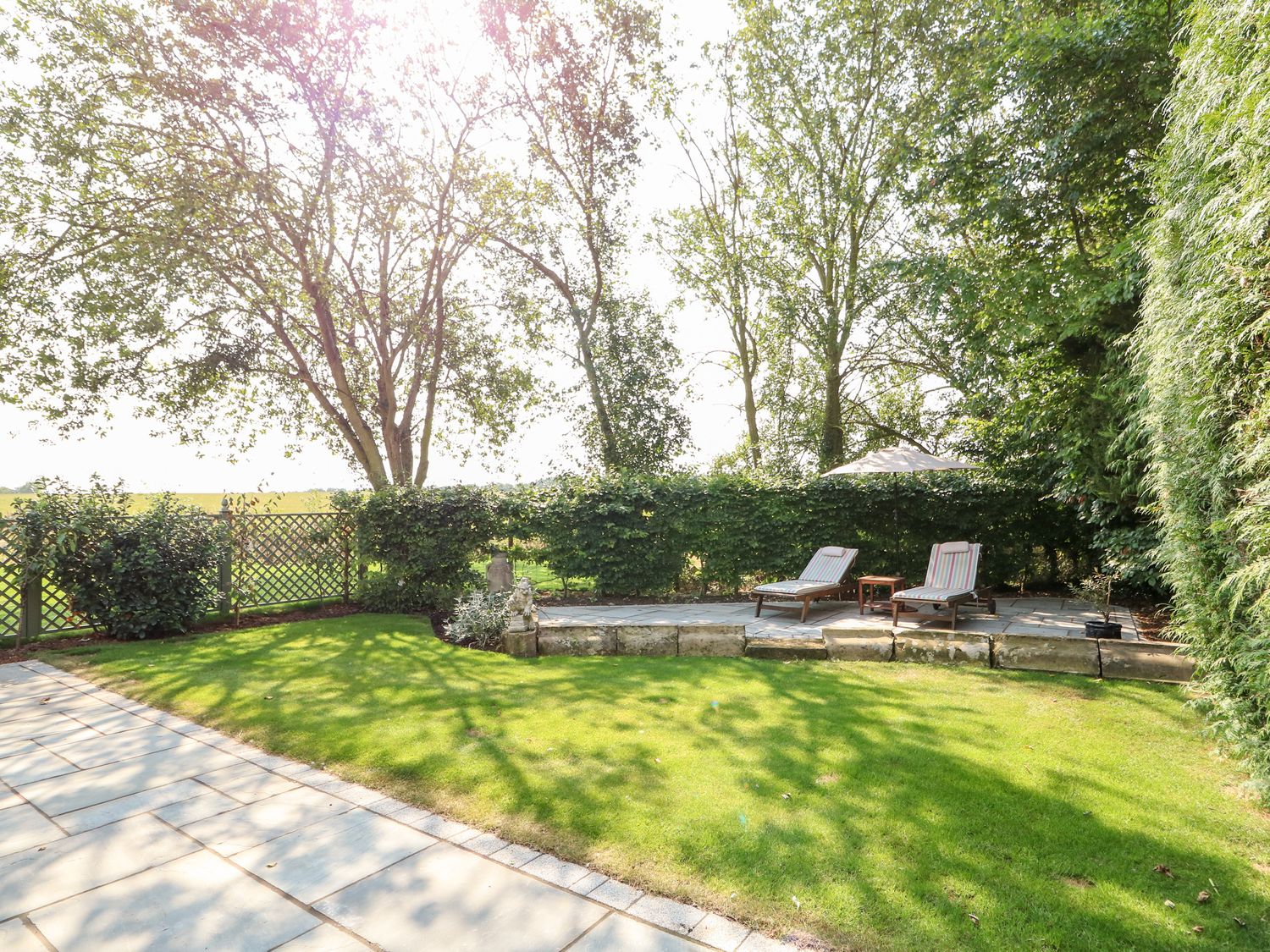 The private garden at The Coach House with lawn and seating