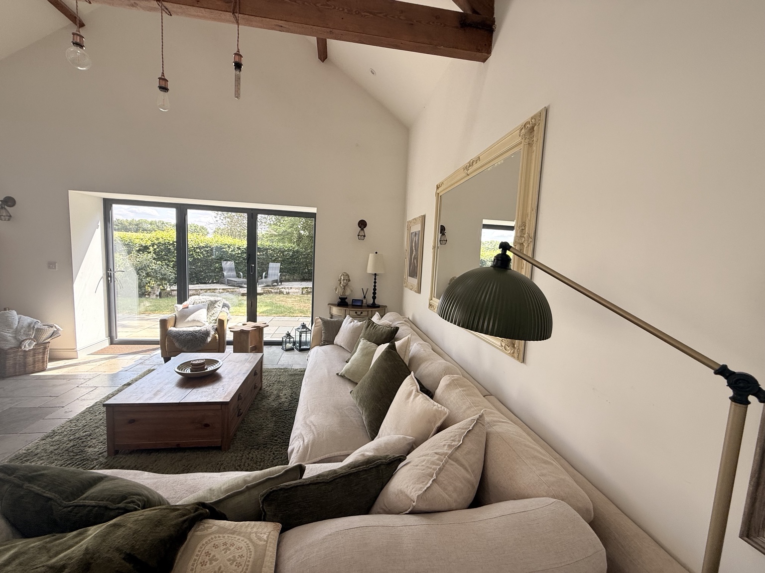 The Coach House sofa and seating beside the doors to the private garden